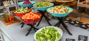 Photo of assorted salads in bowls on a table