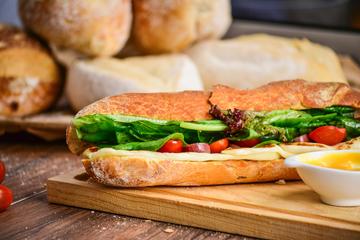 Baguette A baguette filled with cheese and salad on a bread board